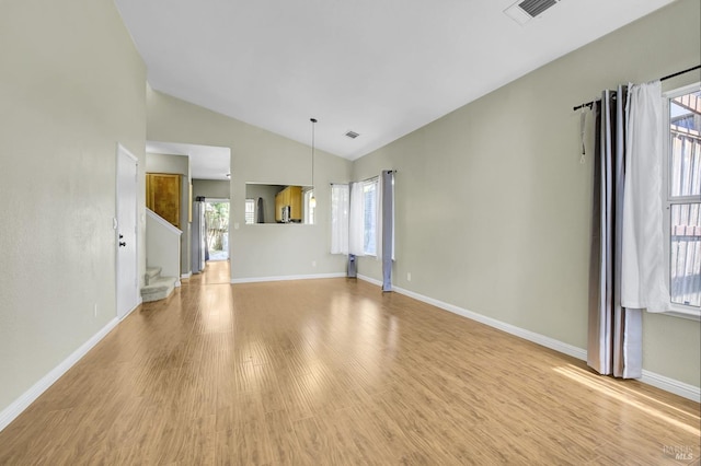 115 Barington Dr, Vallejo, CA 94591 - unfurnished living room with vaulted ceiling, light wood-style floors, baseboards, and stairway
