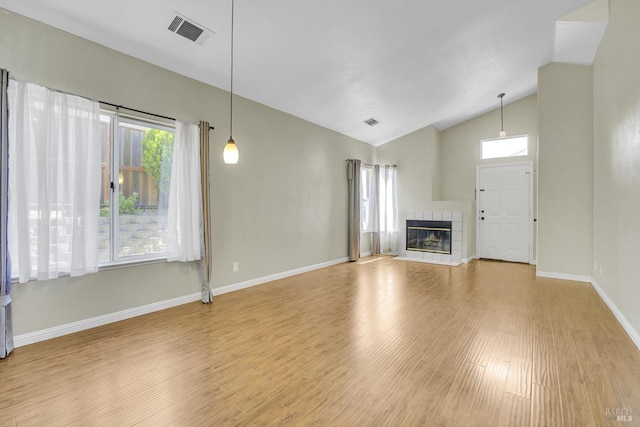 115 Barington Dr, Vallejo, CA 94591 - unfurnished living room featuring wood finished floors, vaulted ceiling, baseboards, and a tile fireplace
