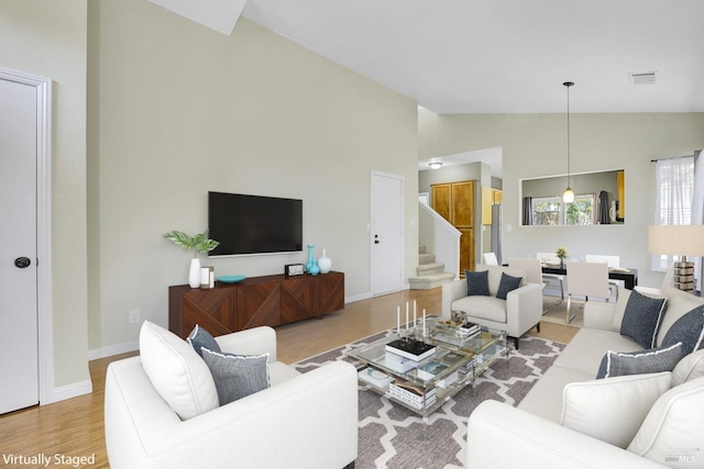 115 Barington Dr, Vallejo, CA 94591 - living area with light wood-type flooring, high vaulted ceiling, stairway, and baseboards