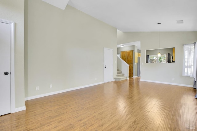 115 Barington Dr, Vallejo, CA 94591 - unfurnished living room with light wood-style floors, stairway, high vaulted ceiling, and baseboards