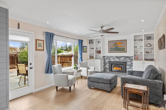 3524 Cascade St, Napa, CA 94558 - living room with light wood-style flooring, a ceiling fan, crown molding, a tiled fireplace, and recessed lighting