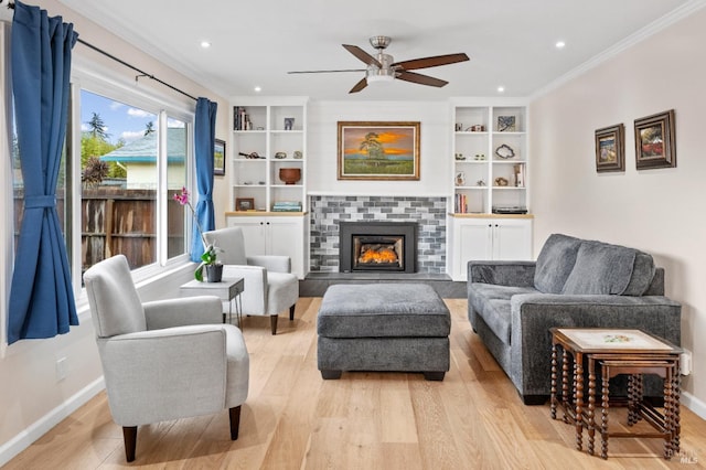 3524 Cascade St, Napa, CA 94558 - living room with crown molding, light wood-type flooring, a ceiling fan, baseboards, and a tile fireplace