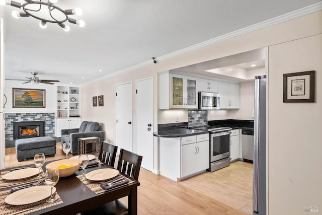 3524 Cascade St, Napa, CA 94558 - kitchen with appliances with stainless steel finishes, dark countertops, light wood-type flooring, glass insert cabinets, and a fireplace