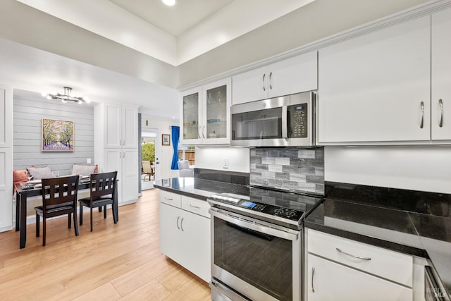 3524 Cascade St, Napa, CA 94558 - kitchen featuring stainless steel appliances, a chandelier, white cabinetry, light wood-type flooring, and glass insert cabinets