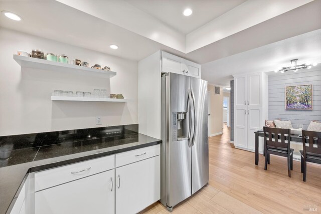 3524 Cascade St, Napa, CA 94558 - kitchen featuring stainless steel refrigerator with ice dispenser, open shelves, white cabinets, light wood finished floors, and dark countertops