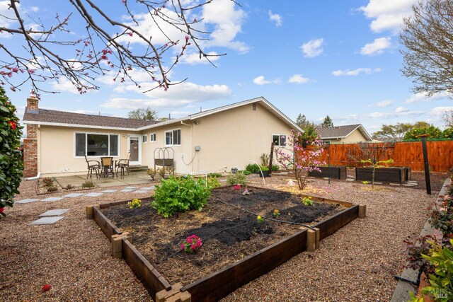 3524 Cascade St, Napa, CA 94558 - rear view of house with a vegetable garden, stucco siding, a patio, and a chimney