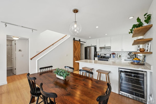 110 Morning Sun Ave, Mill Valley, CA 94941 - dining space with wine cooler, a barn door, stairway, light wood-style floors, and recessed lighting