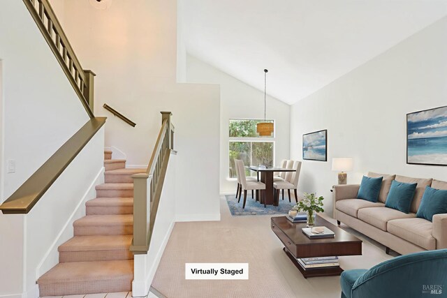 2752 Hillview Dr, Fairfield, CA 94534 - carpeted living area with high vaulted ceiling, stairway, and baseboards