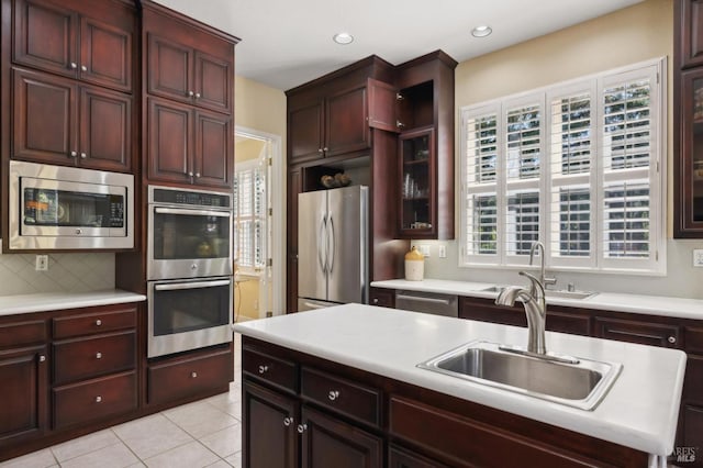 90 Oak Shade Ln, Novato, CA 94945 - kitchen with stainless steel appliances, light countertops, decorative backsplash, light tile patterned floors, and a sink