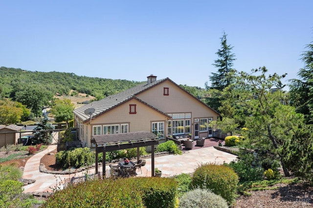 90 Oak Shade Ln, Novato, CA 94945 - rear view of property with a patio, a chimney, an outdoor hangout area, and a forest view