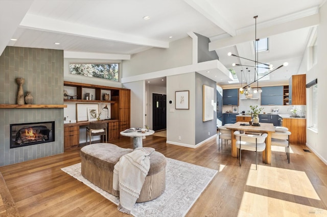 442 Laverne Ave, Mill Valley, CA 94941 - living room featuring a fireplace, beam ceiling, high vaulted ceiling, baseboards, and light wood-type flooring