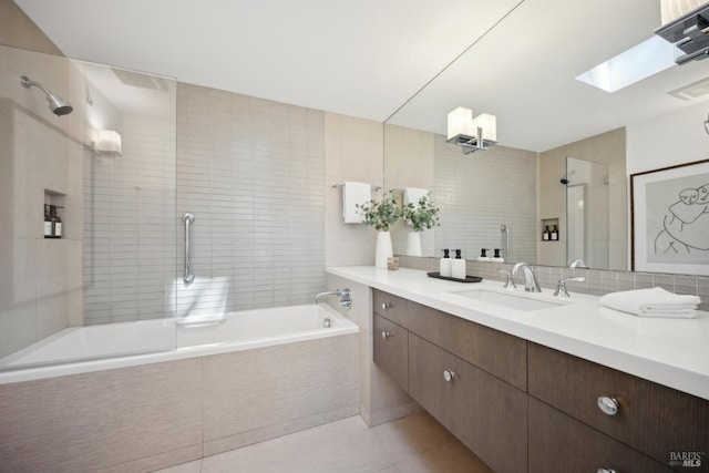 84 Eastview Ave, Tiburon, CA 94920 - bathroom featuring vanity, a skylight, tasteful backsplash, tile walls, and tile patterned flooring