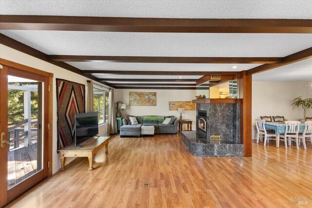 20320 Hollands Ln, Willits, CA 95490 - living area with wood finished floors, beam ceiling, and a fireplace