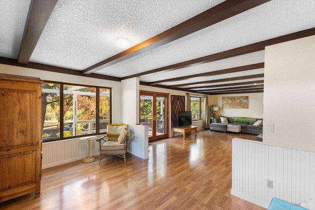 20320 Hollands Ln, Willits, CA 95490 - living area featuring a textured ceiling, beamed ceiling, wood finished floors, and french doors