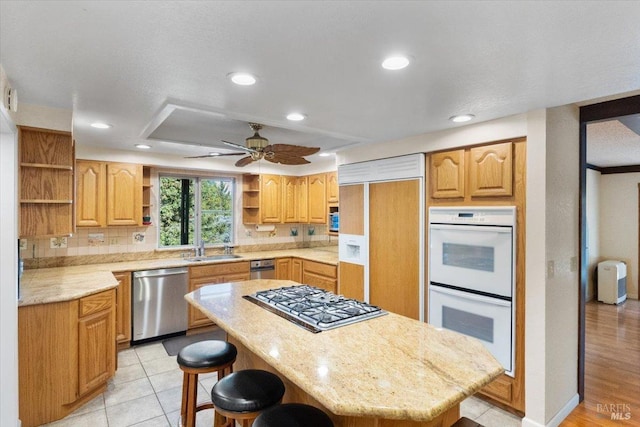 20320 Hollands Ln, Willits, CA 95490 - kitchen featuring appliances with stainless steel finishes, open shelves, a breakfast bar area, a sink, and a kitchen island