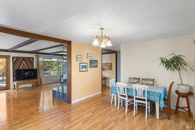 20320 Hollands Ln, Willits, CA 95490 - dining room with light wood finished floors, a textured ceiling, a chandelier, baseboards, and beam ceiling
