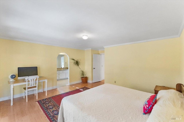20320 Hollands Ln, Willits, CA 95490 - bedroom with arched walkways, crown molding, wood finished floors, baseboards, and ensuite bath