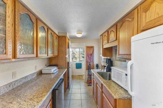 20320 Hollands Ln, Willits, CA 95490 - kitchen featuring white appliances, glass insert cabinets, a textured ceiling, a sink, and brown cabinets