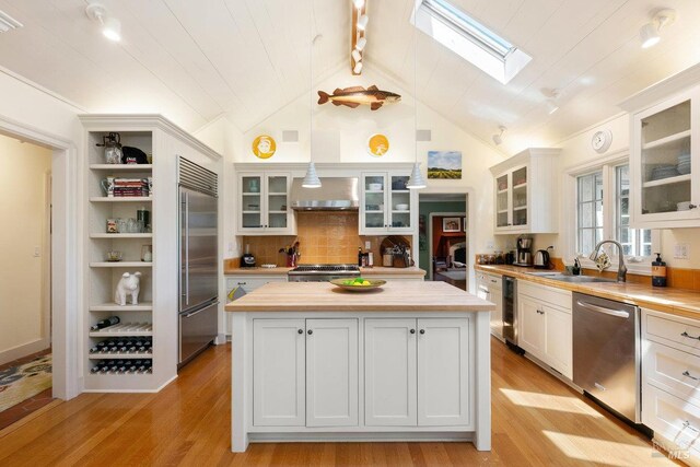 3227 State Highway 128, Calistoga, CA 94515 - kitchen featuring stainless steel appliances, a sink, a skylight, a kitchen island, and beverage cooler