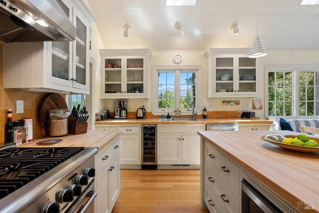 3227 State Highway 128, Calistoga, CA 94515 - kitchen featuring wooden counters, stainless steel appliances, premium range hood, beverage cooler, and plenty of natural light