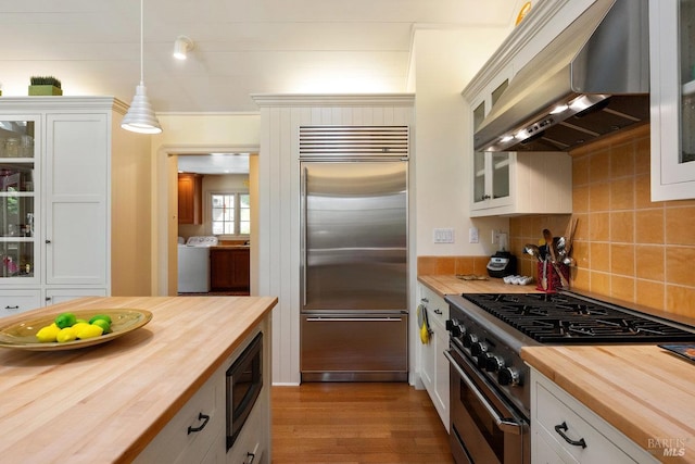 3227 State Highway 128, Calistoga, CA 94515 - kitchen featuring butcher block countertops, built in appliances, wall chimney range hood, and tasteful backsplash