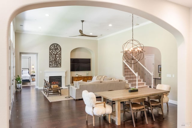 907 Serendipity Way, Napa, CA 94558 - dining space with crown molding, dark wood-type flooring, a lit fireplace, arched walkways, and recessed lighting