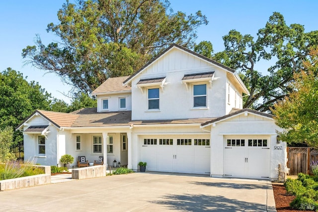 907 Serendipity Way, Napa, CA 94558 - view of front of home featuring concrete driveway, board and batten siding, an attached garage, and stucco siding