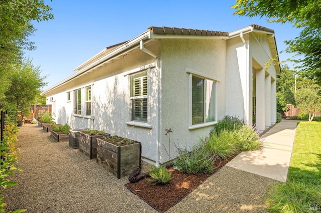 907 Serendipity Way, Napa, CA 94558 - view of home's exterior with stucco siding and a garden