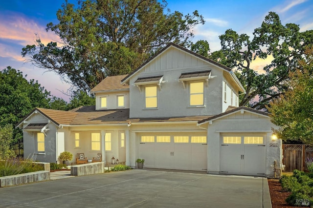 907 Serendipity Way, Napa, CA 94558 - view of front of home featuring concrete driveway, a garage, board and batten siding, and stucco siding