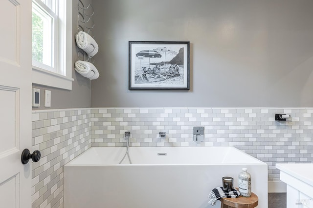 660 S Main St, Sebastopol, CA 95472 - bathroom with tile walls, a soaking tub, and a wainscoted wall