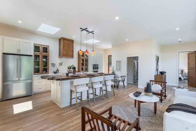 660 S Main St, Sebastopol, CA 95472 - living room with a skylight, light wood-type flooring, recessed lighting, and baseboards