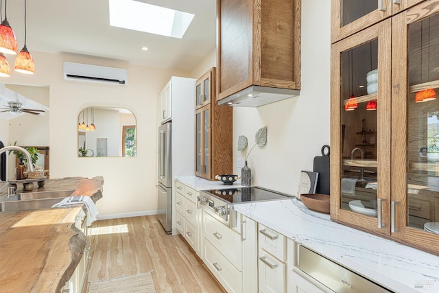 660 S Main St, Sebastopol, CA 95472 - kitchen with a wall mounted air conditioner, freestanding refrigerator, a sink, electric stovetop, and light wood-style flooring