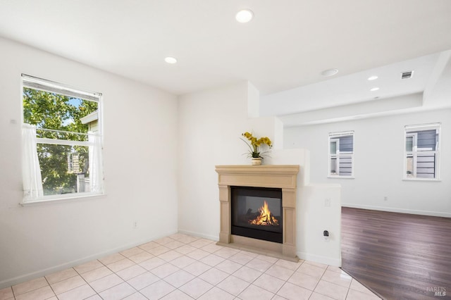 1142 Kellogg St, Suisun City, CA 94585 - unfurnished living room featuring a glass covered fireplace, recessed lighting, baseboards, and light tile patterned floors
