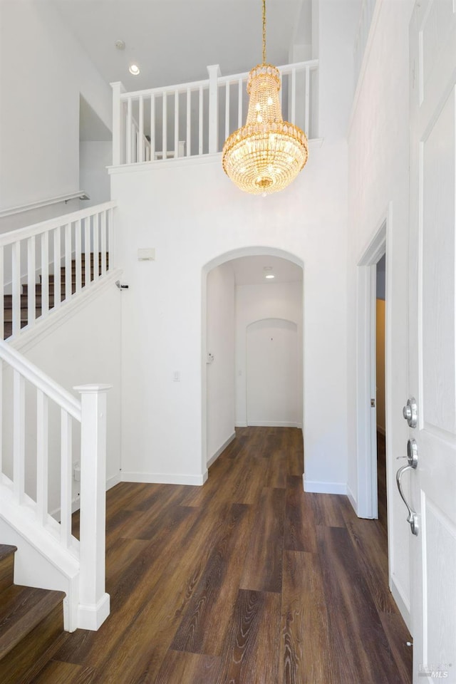 1142 Kellogg St, Suisun City, CA 94585 - entryway featuring a high ceiling, a chandelier, wood finished floors, stairs, and arched walkways