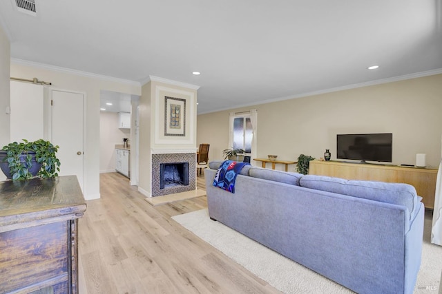 131 Roundtree Blvd, San Rafael, CA 94903 - living area featuring light wood-style flooring, crown molding, a tile fireplace, recessed lighting, and baseboards