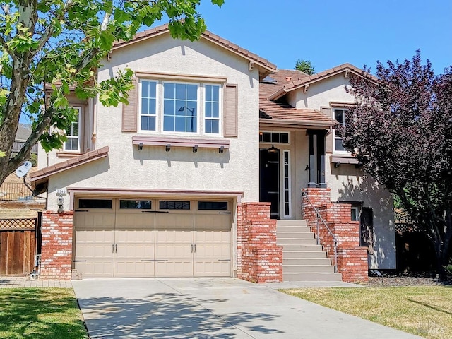 2743 Overlook Dr, Vallejo, CA 94591 - view of front facade with stucco siding, brick siding, an attached garage, and concrete driveway