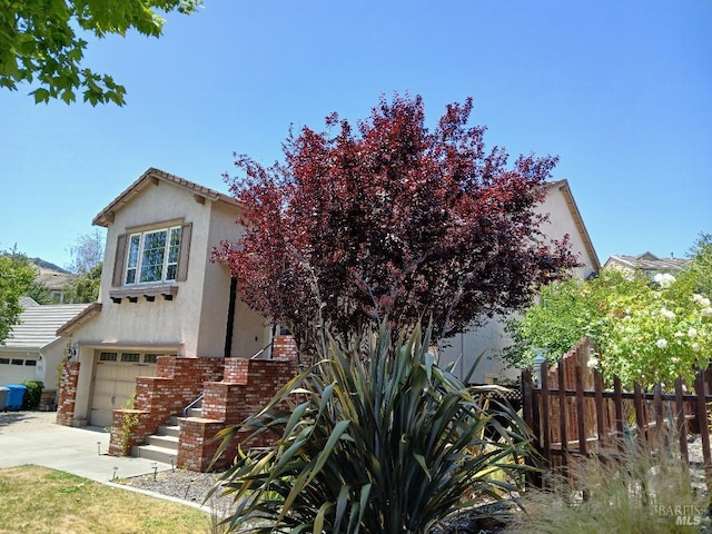 2743 Overlook Dr, Vallejo, CA 94591 - obstructed view of property featuring stucco siding, an attached garage, and concrete driveway