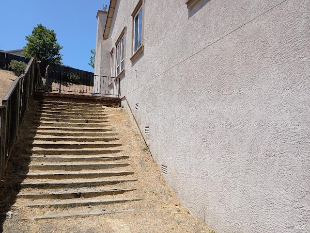 2743 Overlook Dr, Vallejo, CA 94591 - view of home's exterior with stucco siding and stairs