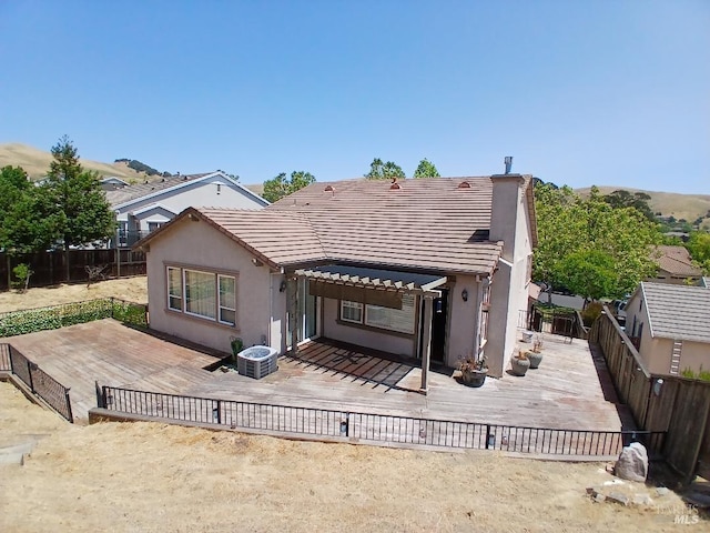 2743 Overlook Dr, Vallejo, CA 94591 - rear view of property featuring a fenced backyard, a tile roof, a wooden deck, and stucco siding