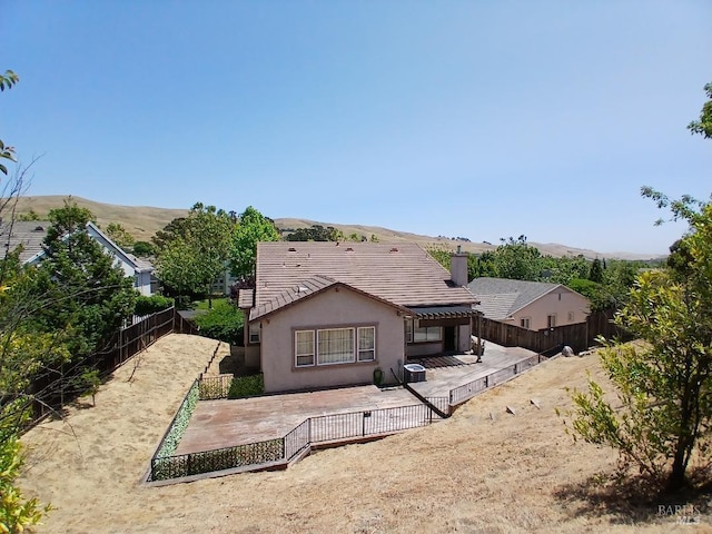 2743 Overlook Dr, Vallejo, CA 94591 - rear view of house featuring a patio area, a fenced backyard, stucco siding, and a tile roof