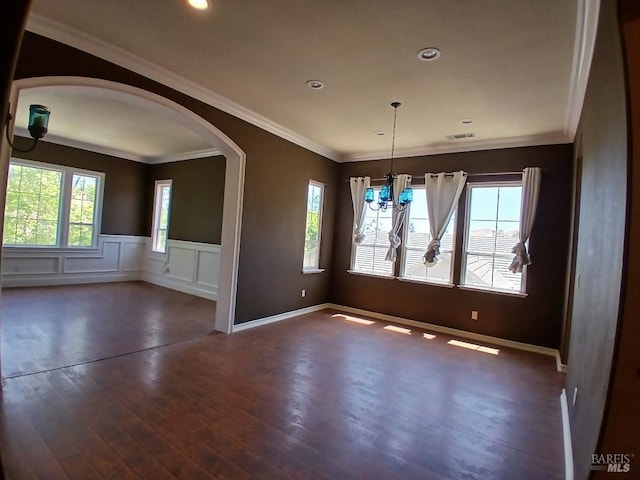 2743 Overlook Dr, Vallejo, CA 94591 - unfurnished room featuring a wainscoted wall, arched walkways, a chandelier, dark wood-style flooring, and crown molding