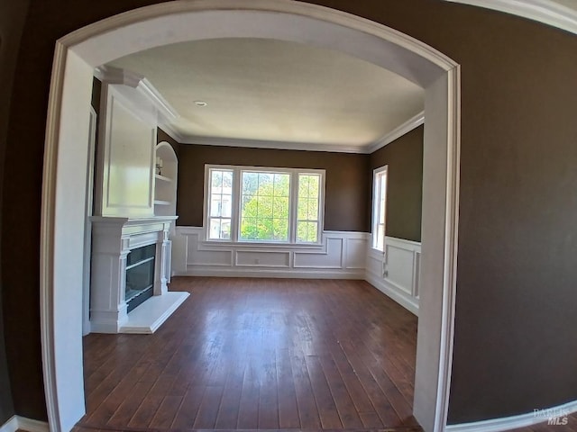 2743 Overlook Dr, Vallejo, CA 94591 - unfurnished living room featuring arched walkways, ornamental molding, dark wood-style floors, a fireplace with raised hearth, and a wainscoted wall