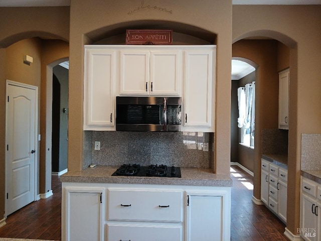 2743 Overlook Dr, Vallejo, CA 94591 - kitchen with stainless steel microwave, black gas stovetop, tasteful backsplash, and dark wood-type flooring
