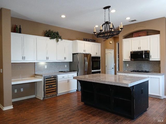 2743 Overlook Dr, Vallejo, CA 94591 - kitchen featuring wine cooler, black appliances, a chandelier, a center island, and tasteful backsplash