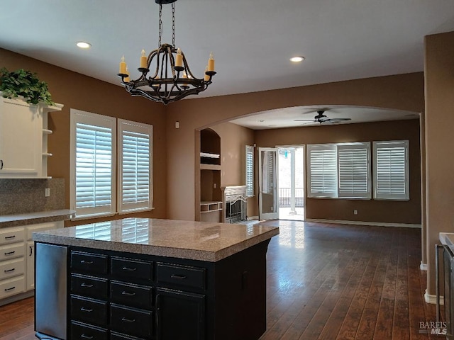 2743 Overlook Dr, Vallejo, CA 94591 - kitchen with arched walkways, dark cabinets, ceiling fan, white cabinets, and open floor plan