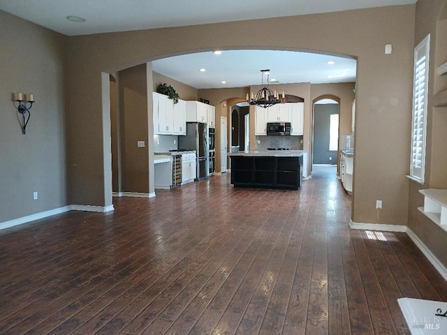 2743 Overlook Dr, Vallejo, CA 94591 - kitchen with stainless steel appliances, arched walkways, light countertops, white cabinetry, and decorative backsplash