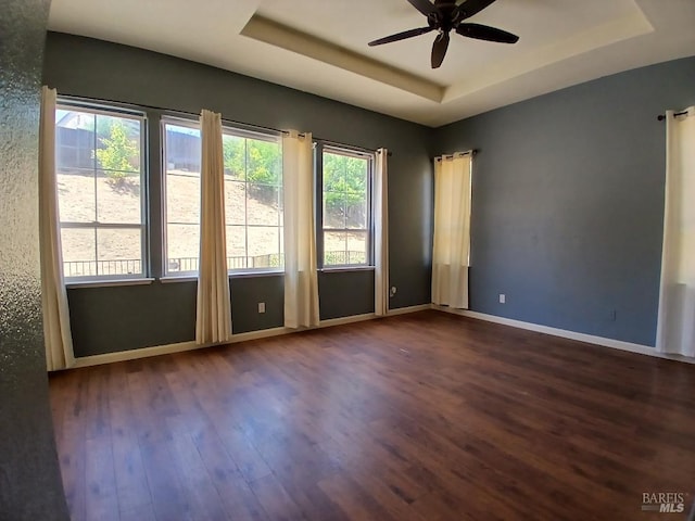 2743 Overlook Dr, Vallejo, CA 94591 - spare room featuring a tray ceiling, dark wood-style floors, a ceiling fan, and baseboards