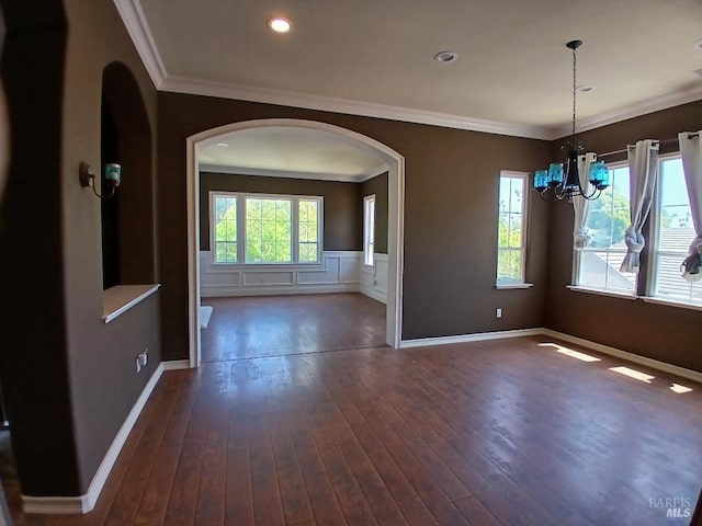 2743 Overlook Dr, Vallejo, CA 94591 - unfurnished dining area with arched walkways, a chandelier, ornamental molding, dark wood-style floors, and wainscoting