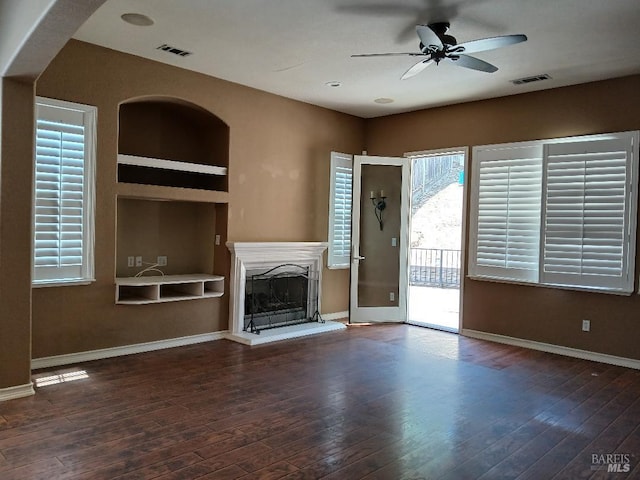 2743 Overlook Dr, Vallejo, CA 94591 - unfurnished living room featuring ceiling fan, a fireplace with raised hearth, wood-type flooring, and baseboards