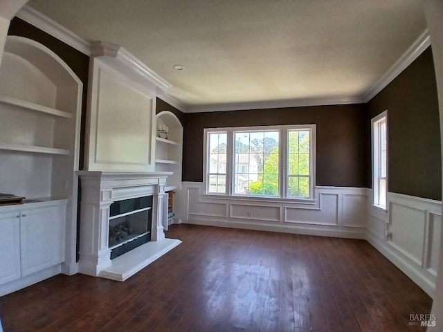2743 Overlook Dr, Vallejo, CA 94591 - unfurnished living room with dark wood-style flooring, a wainscoted wall, a glass covered fireplace, built in features, and crown molding